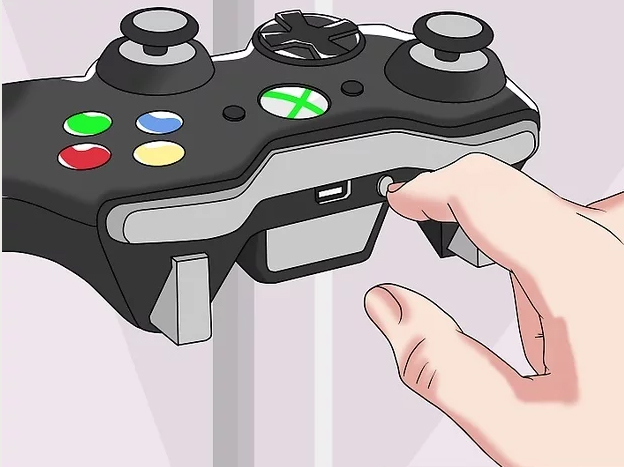 Bouton de synchronisation sur la manette de jeu.