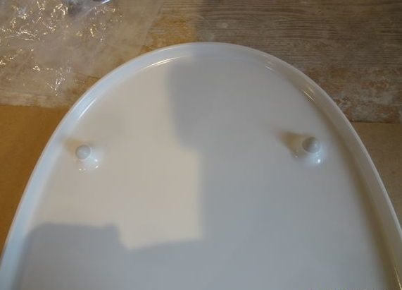 Les ronds sont fixés au couvercle et les allongés sont fixés au siège des toilettes.